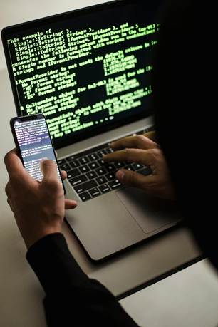 A person using a cell phone and a computer

AI-generated content may be incorrect.